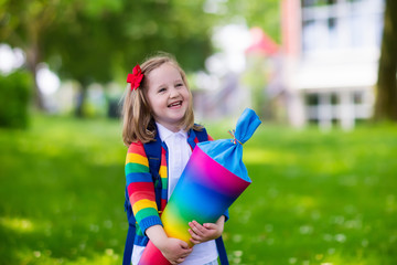 Little child with candy cone on first school day