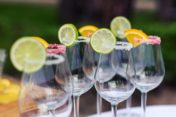 Empty glasses with slices of lime and lemon, decorated sugar