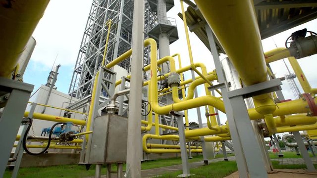 yellow pipe on gas plant. shot with slider
