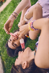 Two young girls eating ice cream, leisure concept