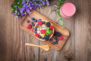 Tasty ice cream dessert with fruit in a waffle bowl.