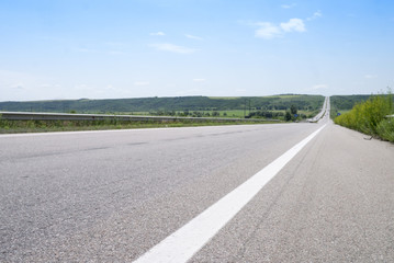 View on the empty road way to horizon in midday summer 