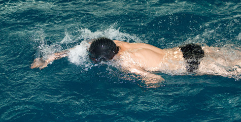 boy goes in for sports in the pool