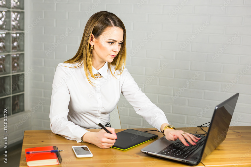 Aufkleber young female designer using graphics tablet while working with computer