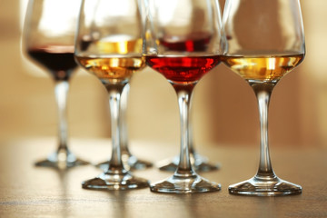 Many glasses of different wine in a row on a table