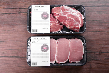 Packed pieces of pork meat on wooden background