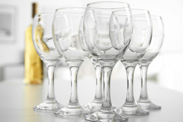 Wineglasses on blurred interior background