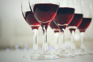 Glasses of red wine on white table closeup