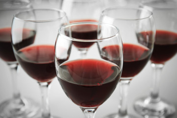 Glasses of red wine on white table closeup