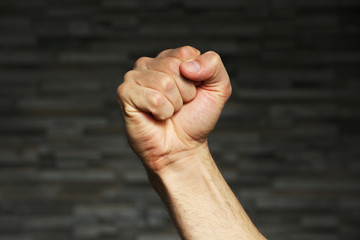 Male fist on grey background