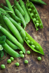 Ripe Green peas on wooden table