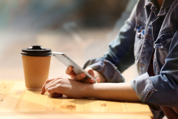 Fototapeta na wymiar Young woman sitting in cafe with coffee
