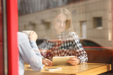 Young happy women talking in cafe