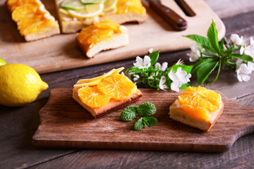 Delicious citrus cake on wooden background