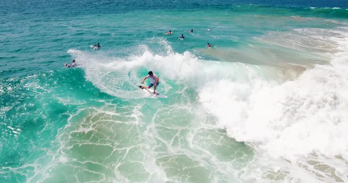 Aerial View of Surfer Riding Blue Ocean Wave at Perfect Tropical Point Break. Drone Summer Extreme Sports
