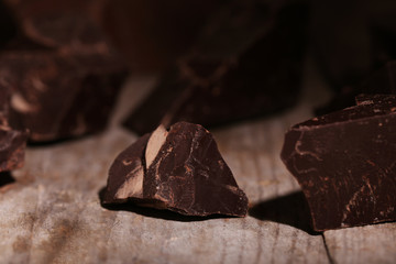 Chocolate bar pieces  on wooden background