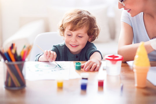 Little boy painting a picture