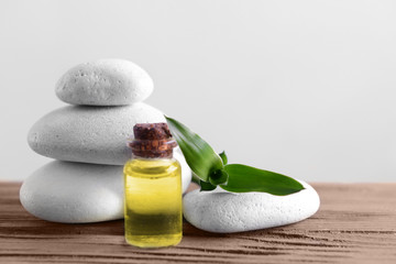 White spa stones with oil on light background