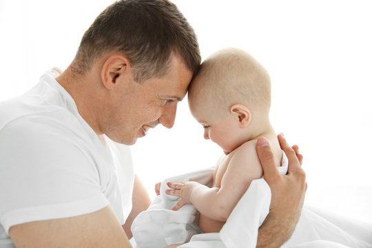 Father playing with smiling baby