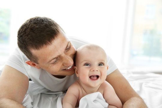 Portrait of happy father and cute baby