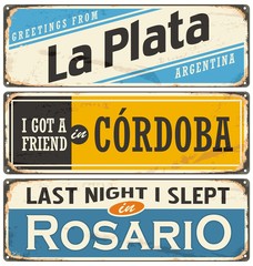 Vintage tin sign collection with Argentina city names