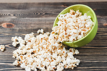 Sweet Caramel Popcorn in Green Bowl on Wooden Background