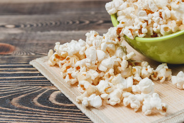 Sweet Caramel Popcorn in Green Bowl on Wooden Background
