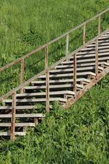 Old metal staircase climbing up a steep hill