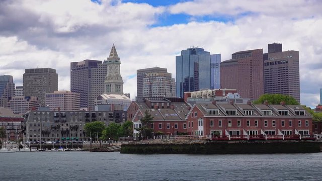 BOSTON, MA - Circa June, 2016 - A daytime establishing shot of the Boston skyline as seen from the harbor.	 	