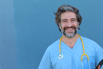 Portrait of happy male doctor holding folder with notes isolated over blue background with copy space