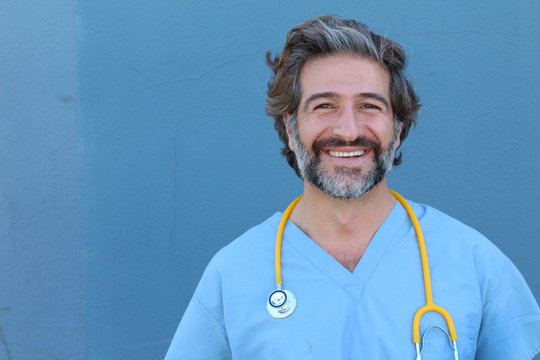 Portrait of a smiling handsome doctor with salt and pepper hair 