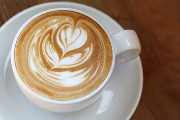 Close-up cup of latte coffee on wooden (Selective focus)