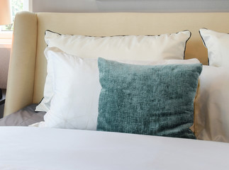 bedroom interior design with white and green pillows on white bed