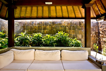 Fototapeta na wymiar Outside patio area with a sofa and traditional room