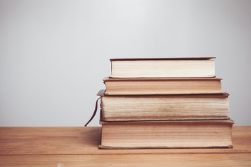 Vintage tone of old books on wooden deck table