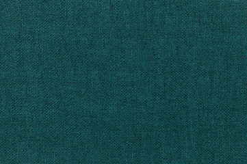 Dark green background from a textile material. Fabric with natural texture. Backdrop.