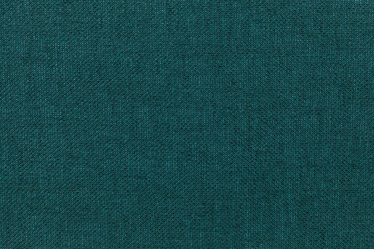 Dark green background from a textile material. Fabric with natural texture. Backdrop.