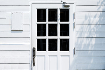 Door in the wood white wall.