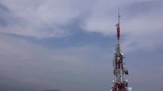 Timelapse of a radio tower against a blue sky