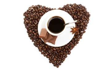 white cup of coffee on  beans as a heart