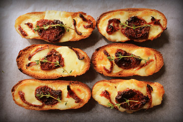 Obraz na płótnie Canvas Sandwich with mozzarella, sun-dried tomatoes and thyme 