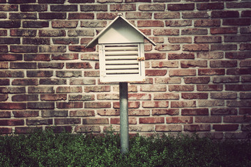 Post box on brick wall background,vintage filter