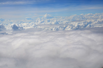 View from the window of an airplane flying in the clouds