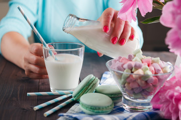 Woman pour milk in glass