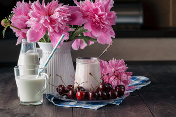 Homemade cherry yogurt in the glass cups on table