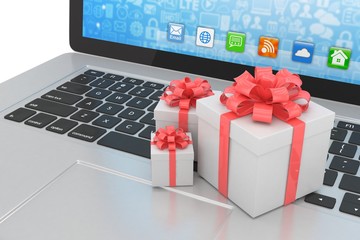 Gift box with ribbon bow on laptop keyboard. 3d rendering.