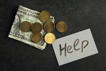 the change and crumpled dollar near pieces of paper with inscription 