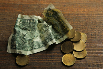 money and paper on a brown wooden background.The concept of poverty