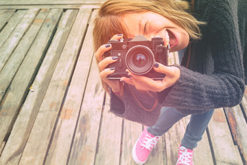 Girl holding a retro camera.
