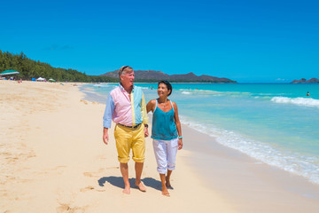 Retirement Couple Strolling Tropical Beach in Hawaii